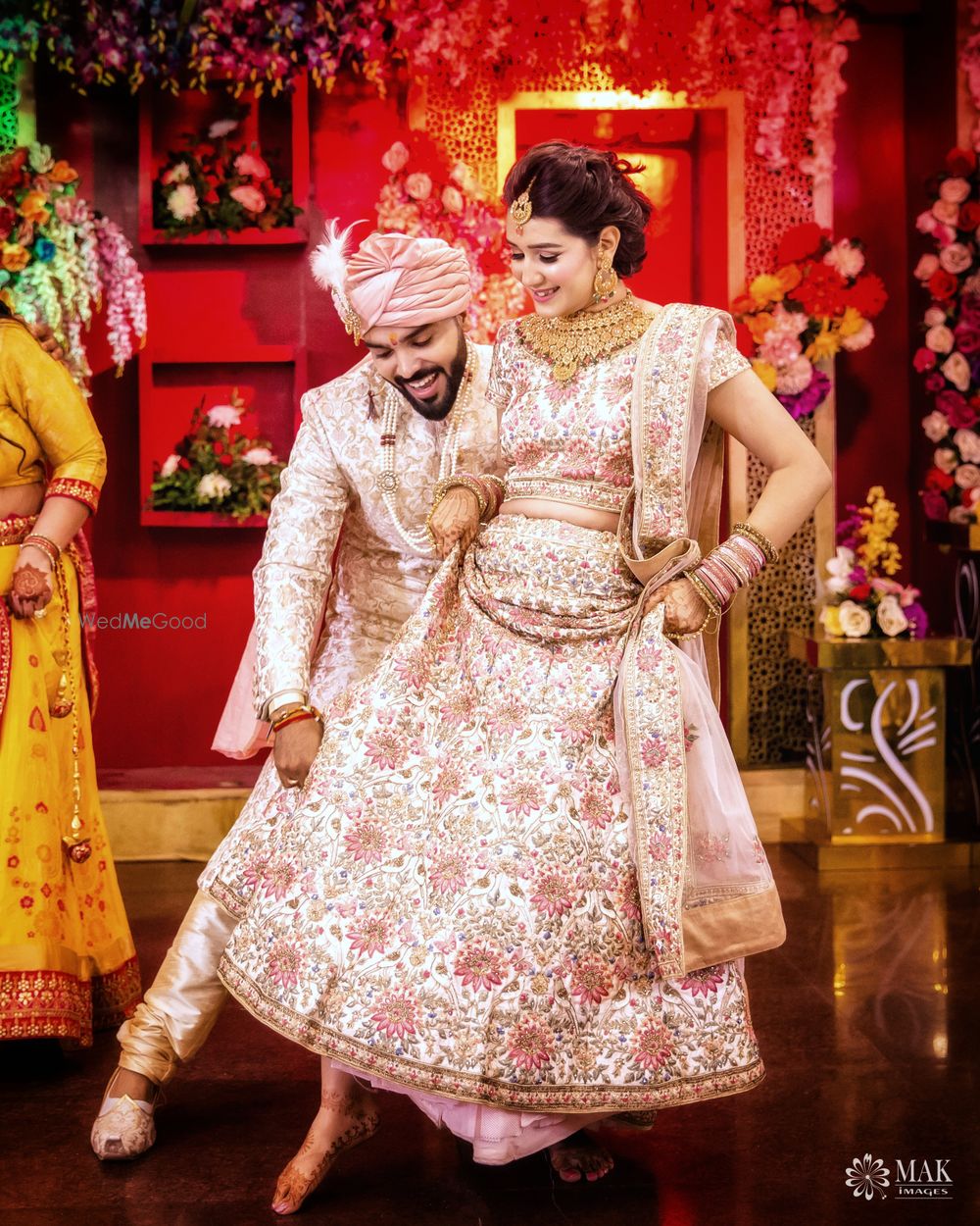 Photo of Matching bride and groom portrait with floral work outfits