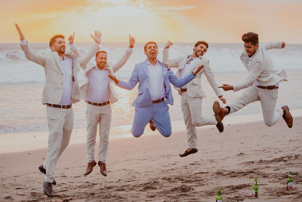 Photo of Jumping shot of groom with groomsmen