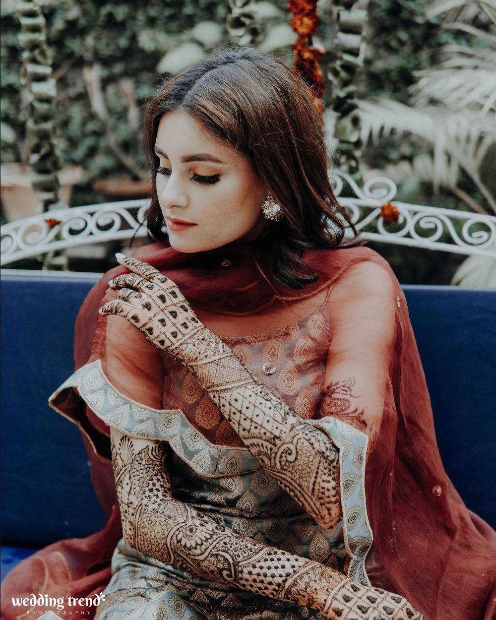 Photo of bridal portrait while showing off her mehendi