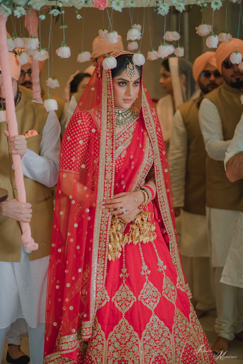 Photo of Bride entering with phoolon ki chadar with hanging roses
