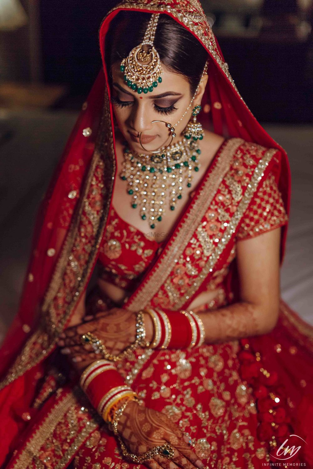 Photo of Bridal portrait with red lehenga and green jewellery