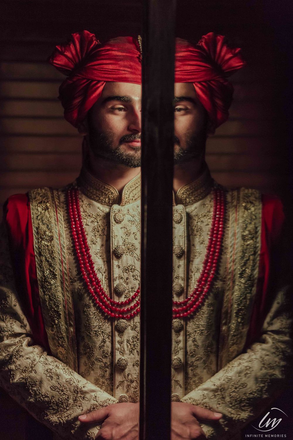 Photo of Modern groom portrait in red safa and necklace