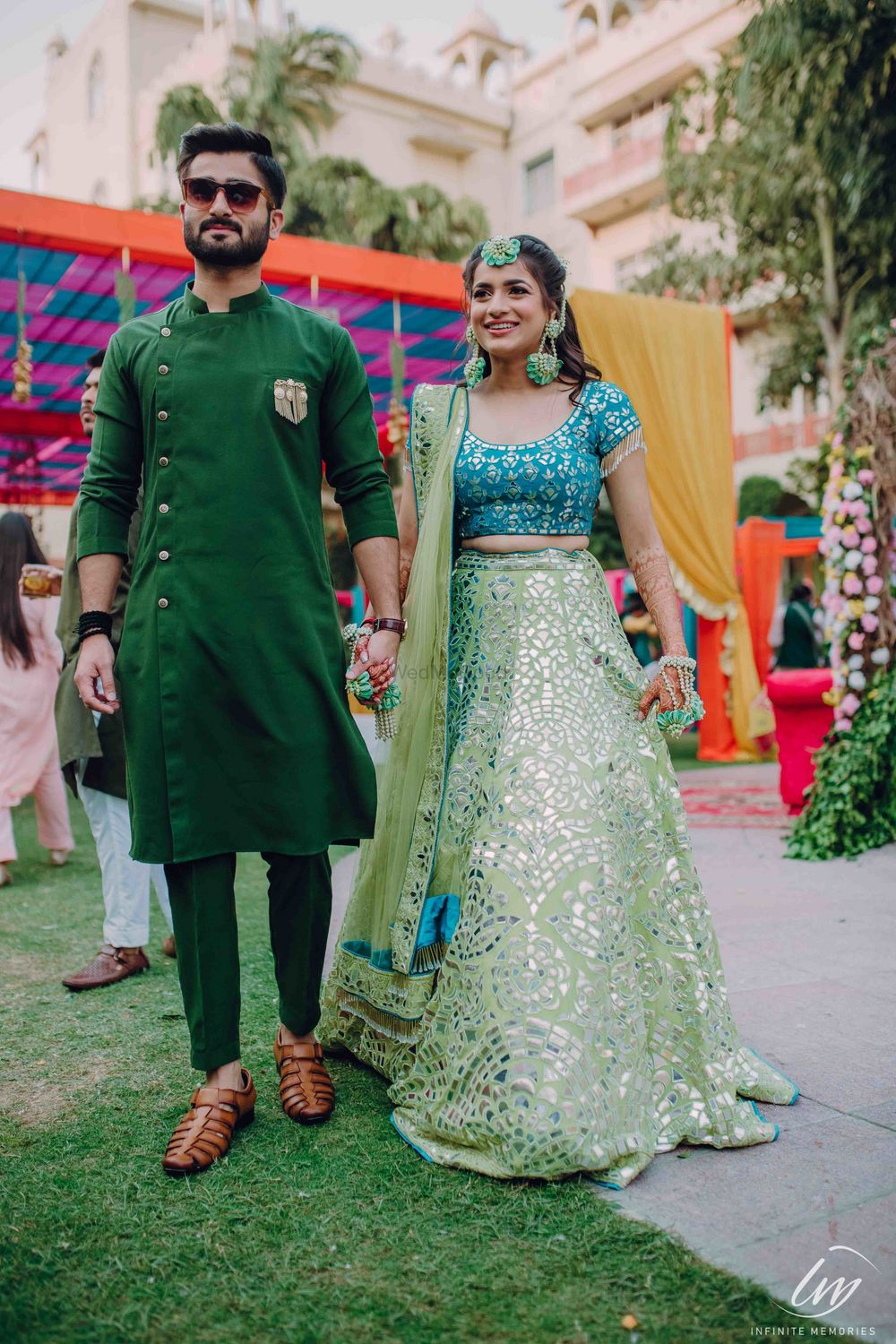 Photo of Bride and groom on mehendi in contrasting outfits of same shade