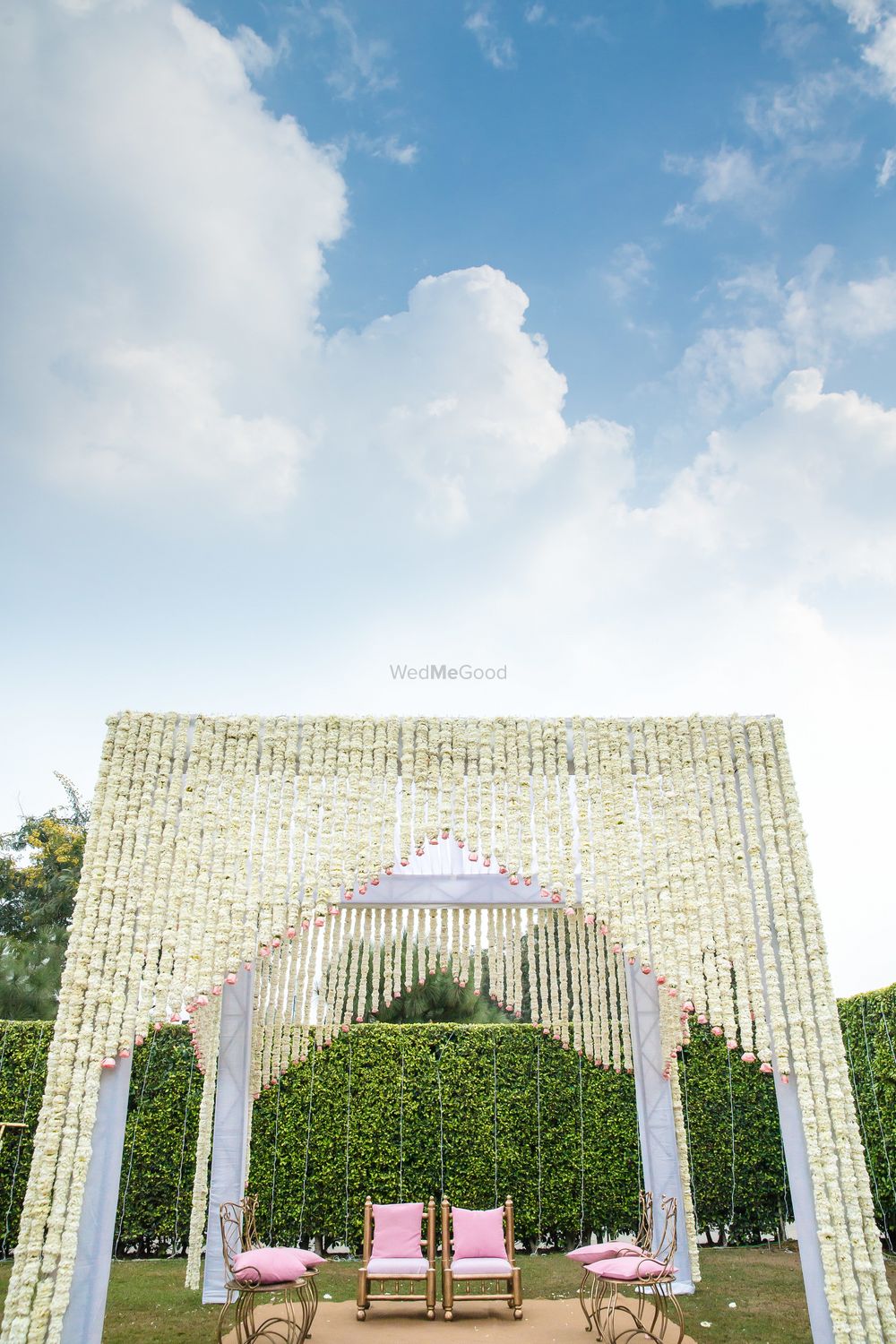 Photo of Mandap decor with white suspended flowers