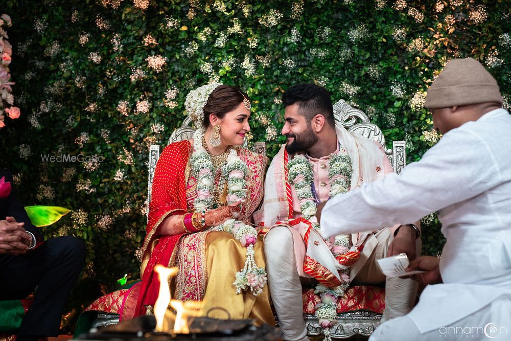 Photo of Cute couple shot in fusion wedding with couple wearing babys breath jaimalas