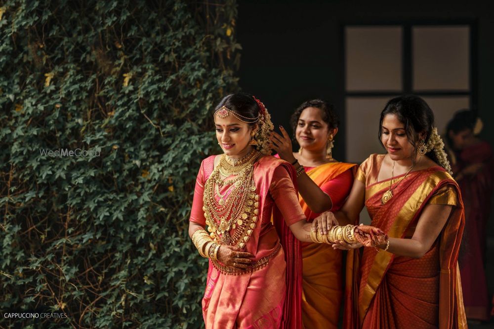 Photo of A south Indian bride getting ready with her bridesmaids