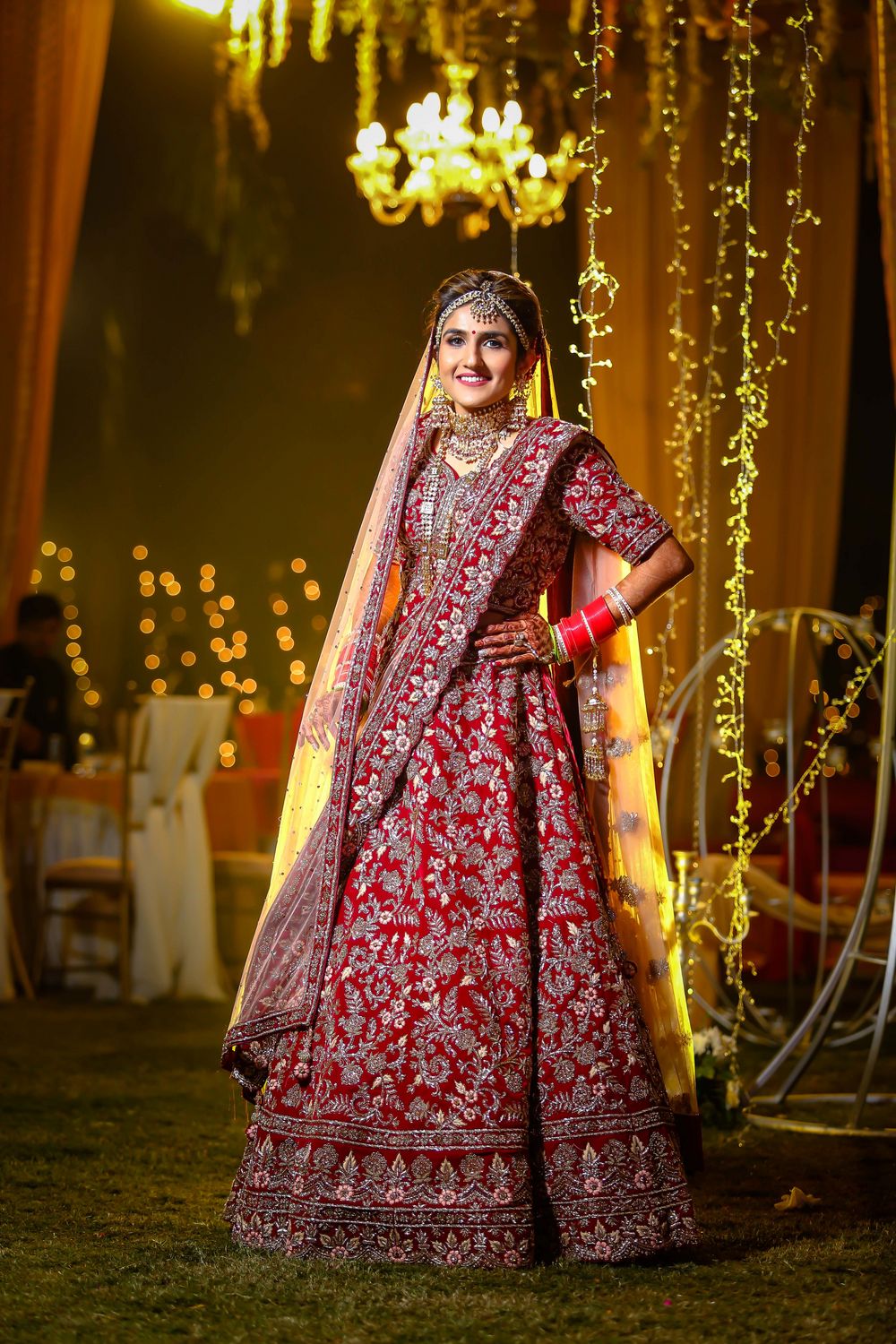 Photo of Beautiful north Indian bride looking stunning in red bridal lehenga.