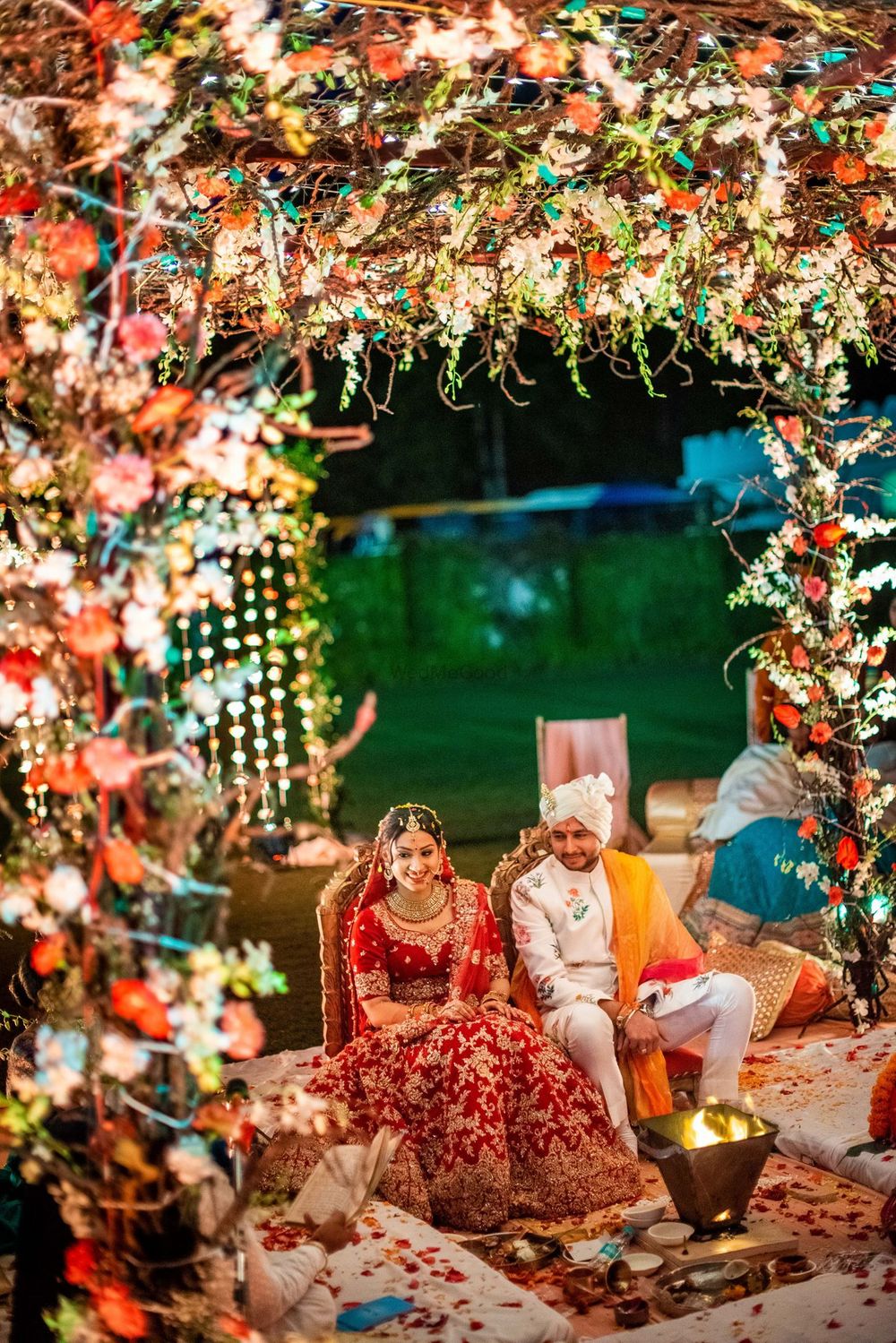 Photo of A couple at their floral mandap