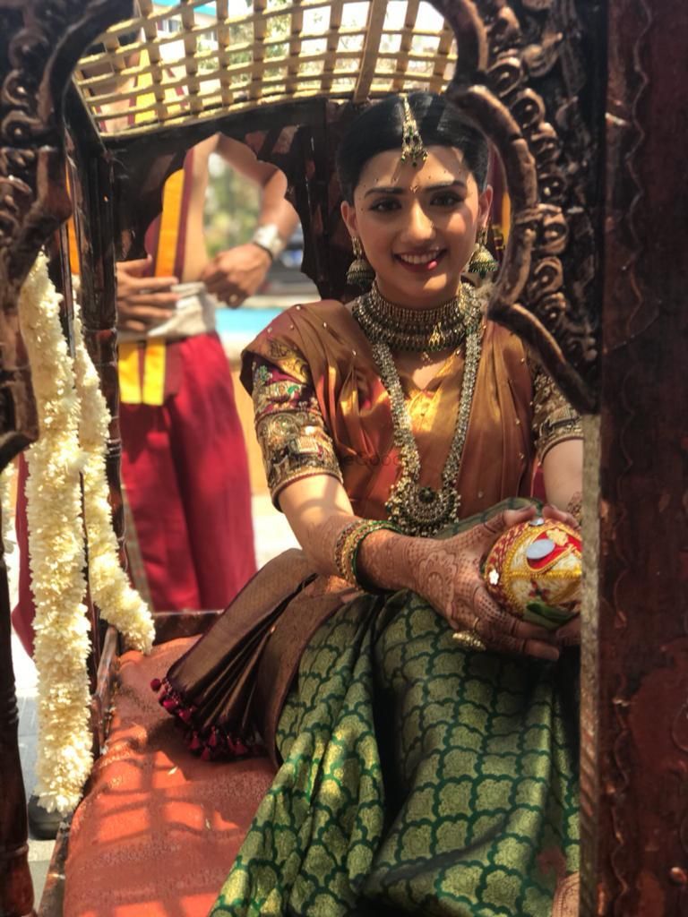 Photo of South Indian bride wearing a yellow and green saree
