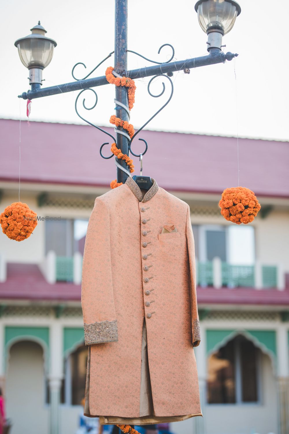 Photo of Layered peach sherwani on hanger