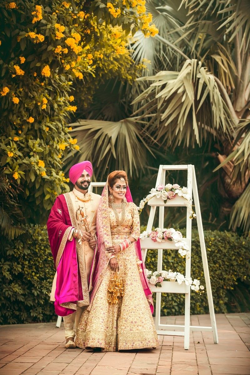Photo of Coordinated bride and groom wearing pink and gold