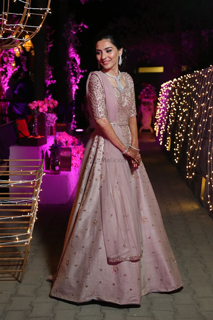 Photo of A happy bride in a pastel anarkali on her reception.