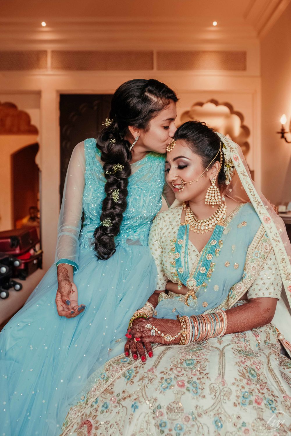 Photo of Bride with sister kissing her forehead