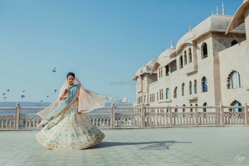 Photo of Twirling bride in an offbeat bridal lehenga with a pop of blue