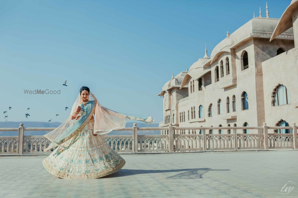 Photo of Twirling bride in an offbeat bridal lehenga with a pop of blue