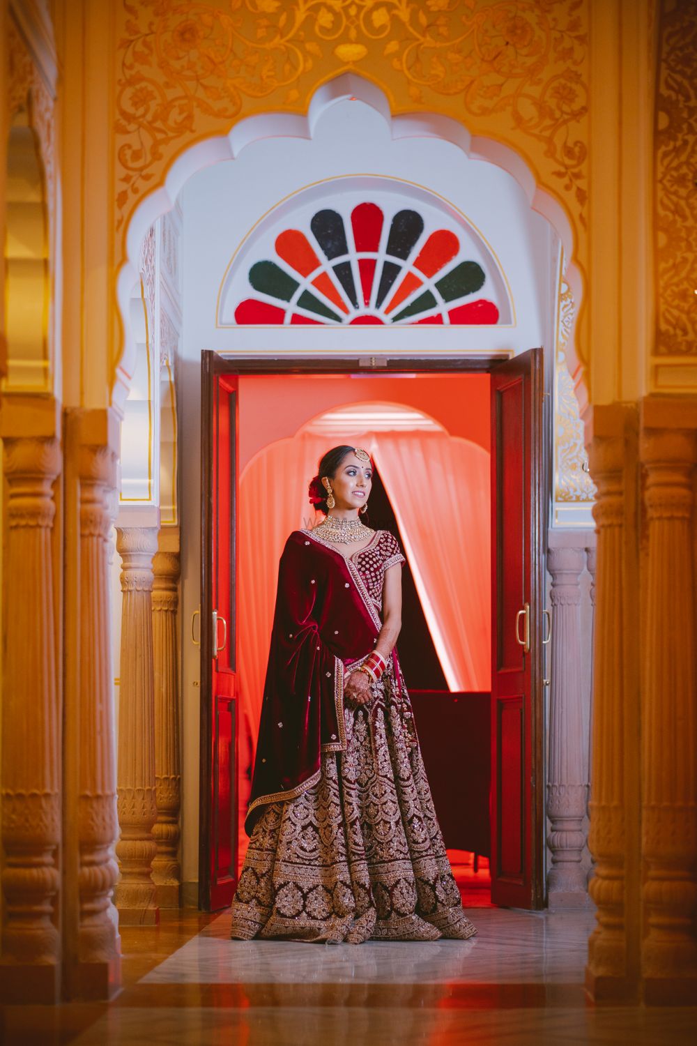 Photo of Bride in velvet lehenga and dupatta in maroon
