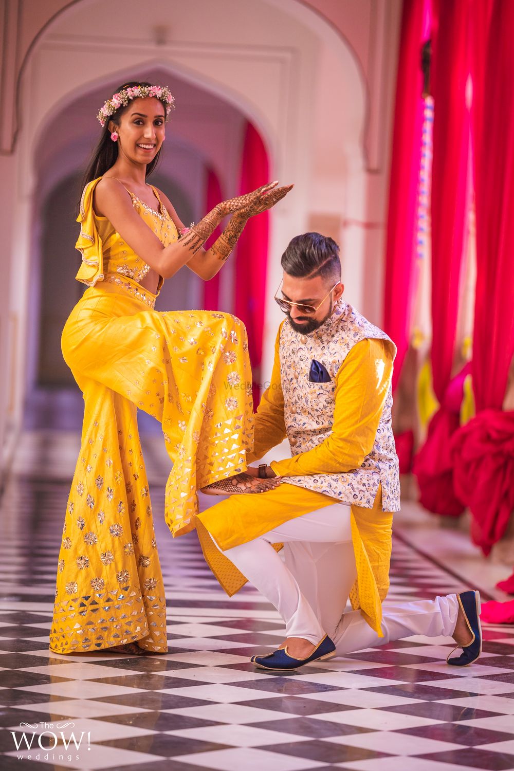 Photo of A couple in coordinated yellow outfits for their mehndi