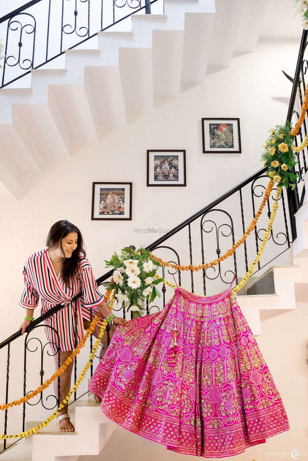 Photo of Bride getting ready shot with bright pink lehenga on hanger