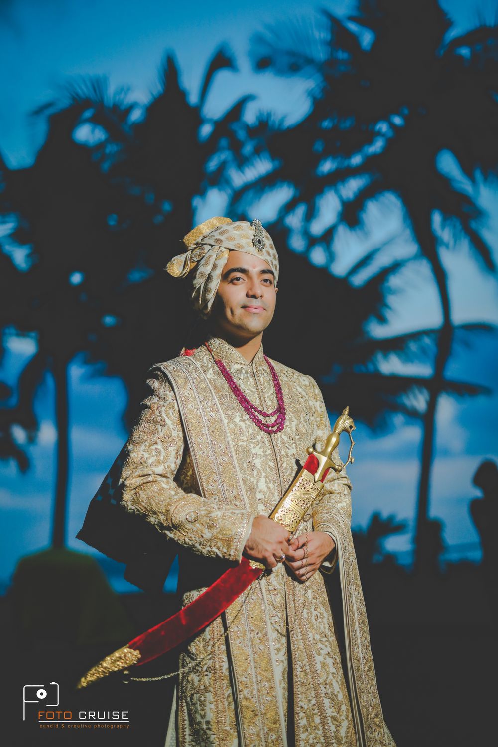 Photo of A groom dressed in gold embroidered sherwani