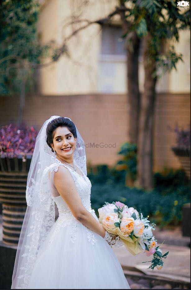 Photo of White Net Wedding Gown with Floral Bouquet