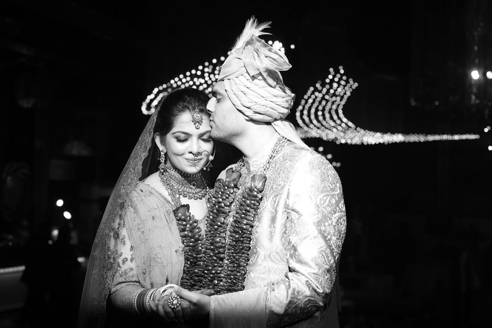 Photo of Groom showering all his love on his bride.