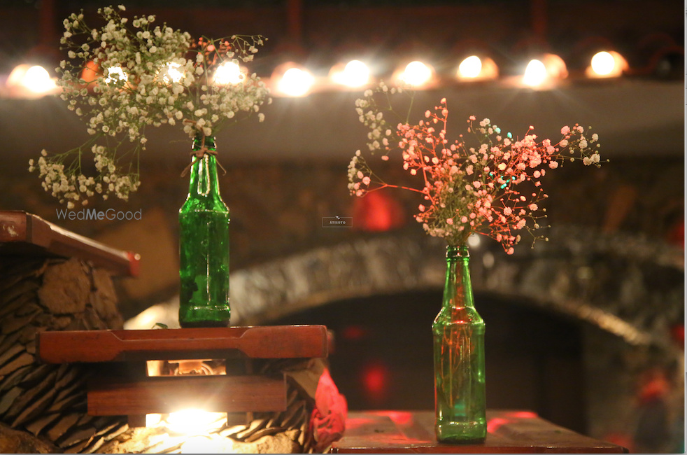 Photo of Green Bottles as Floral Vase with Fairy Lights Decor