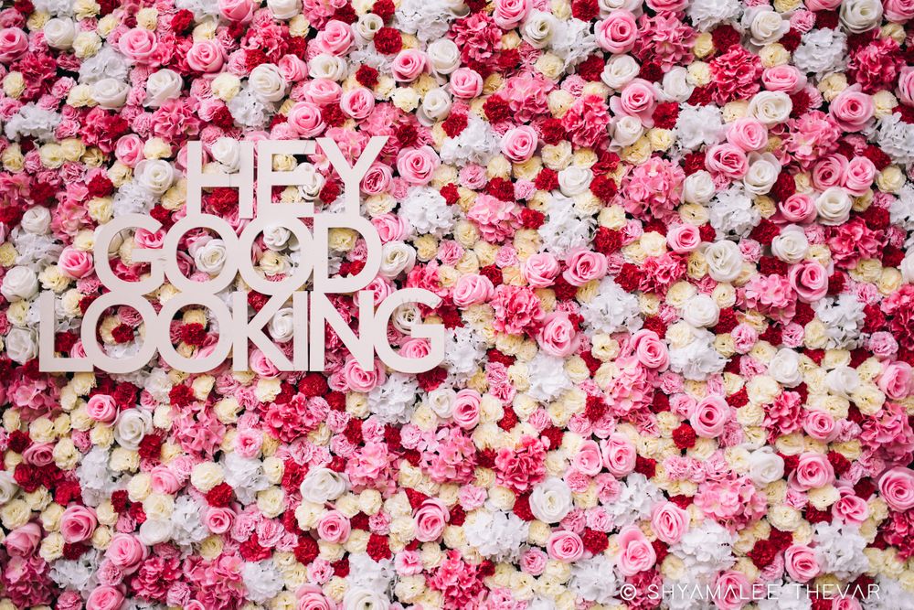 Photo of Unique stage backdrop with floral wall and saying