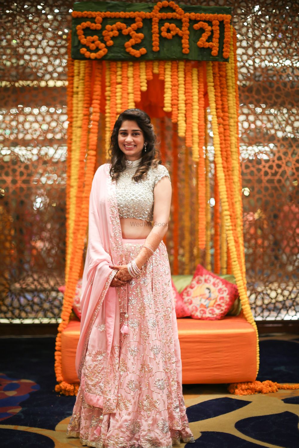 Photo of A bride to be in a silver and pink lehenga for her mehndi