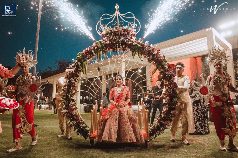 Photo of Unique grand bridal entry on an arch