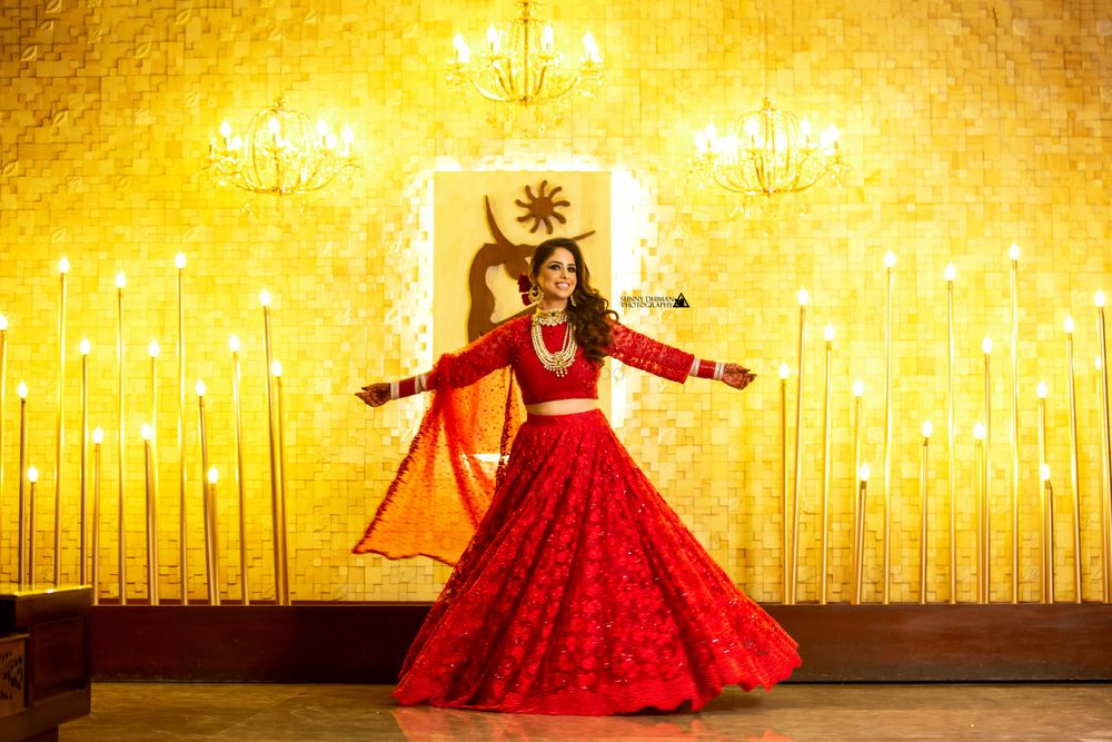 Photo of Bride dancing on reception in red lehenga