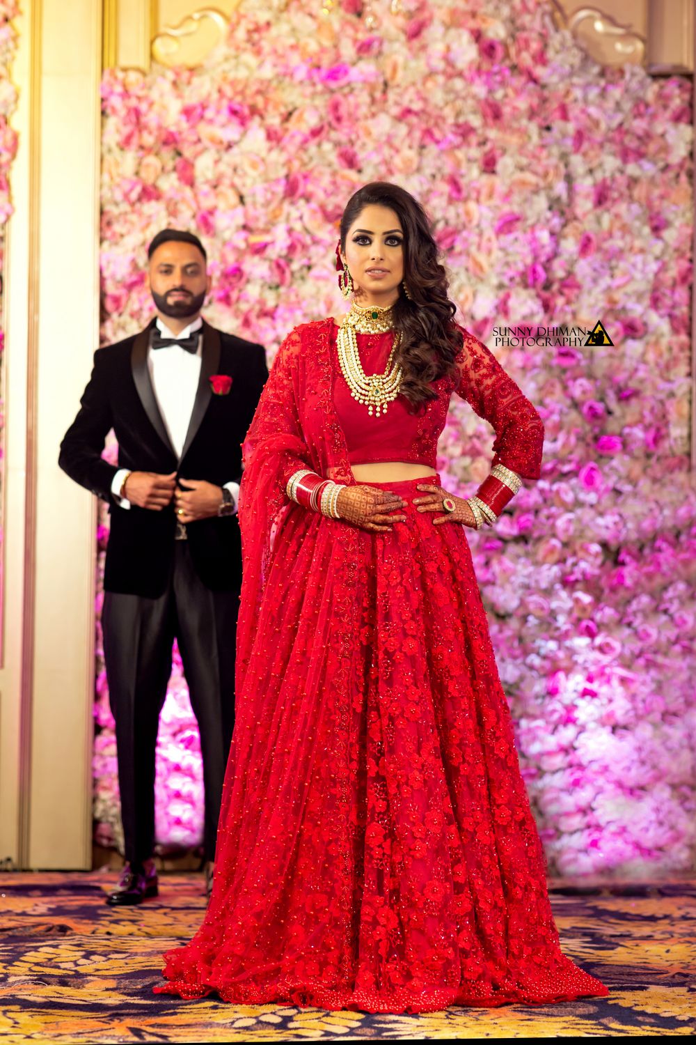 Photo of Bride in red lace lehenga for reception