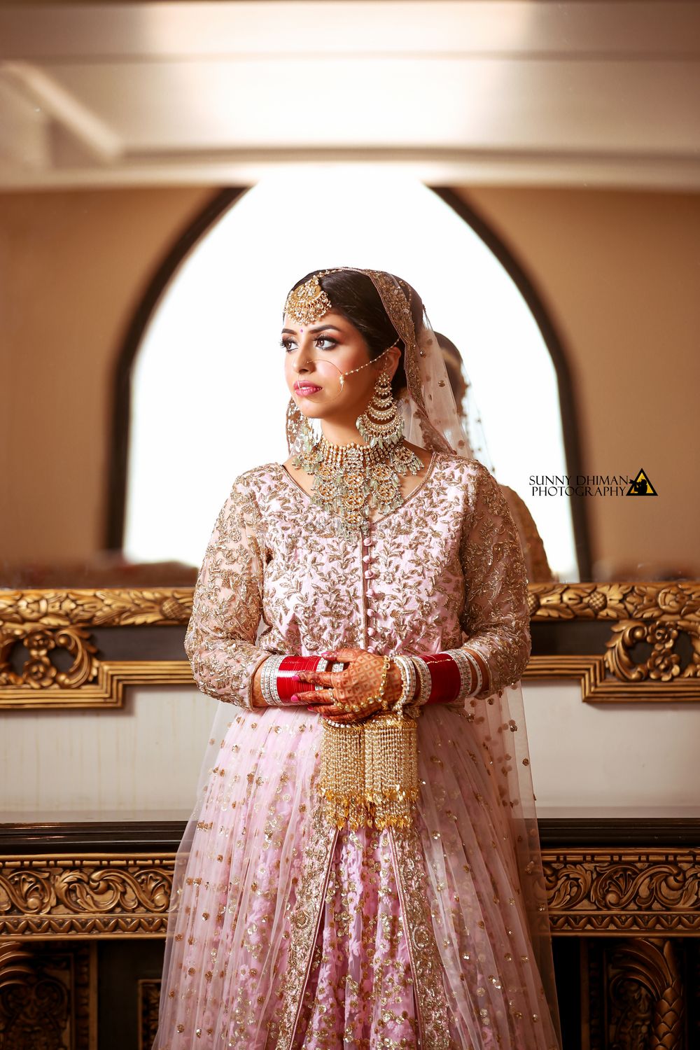 Photo of Bridal lehenga in light pink lehenga and gold kaleere