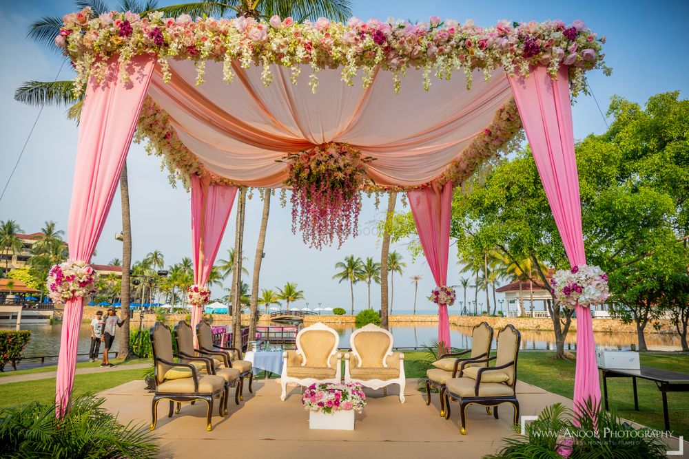 Photo of An open mandap with floral strings and drapes