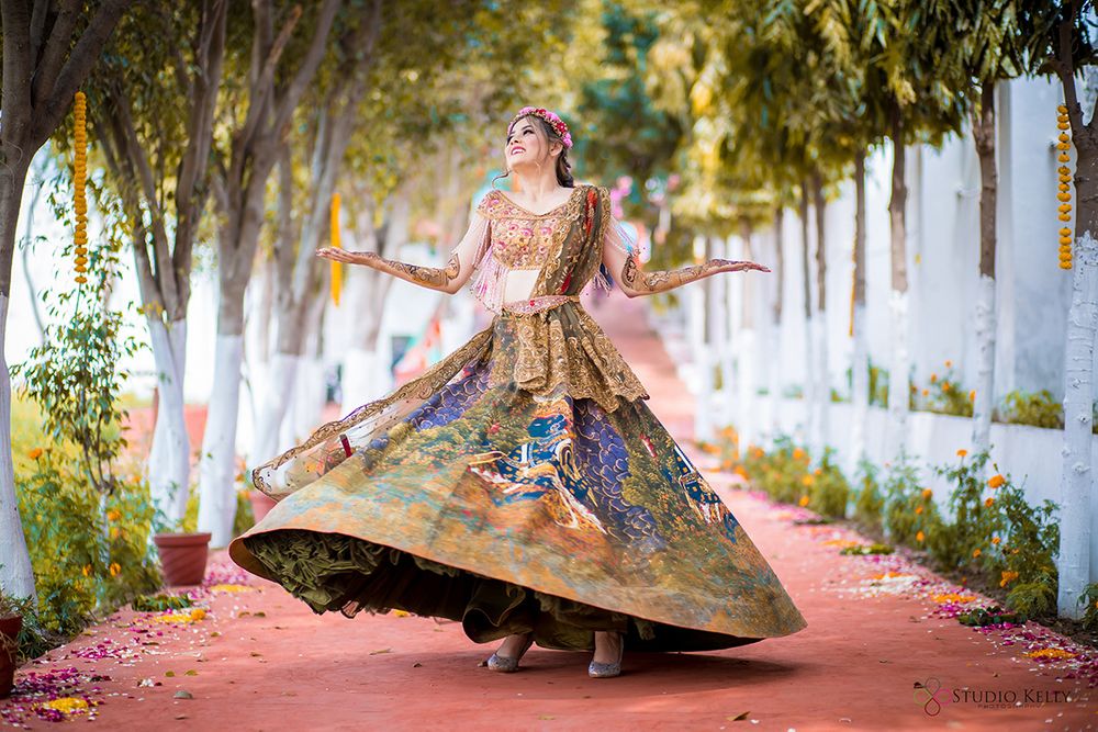 Photo of A bride twirls in her mehndi outfit
