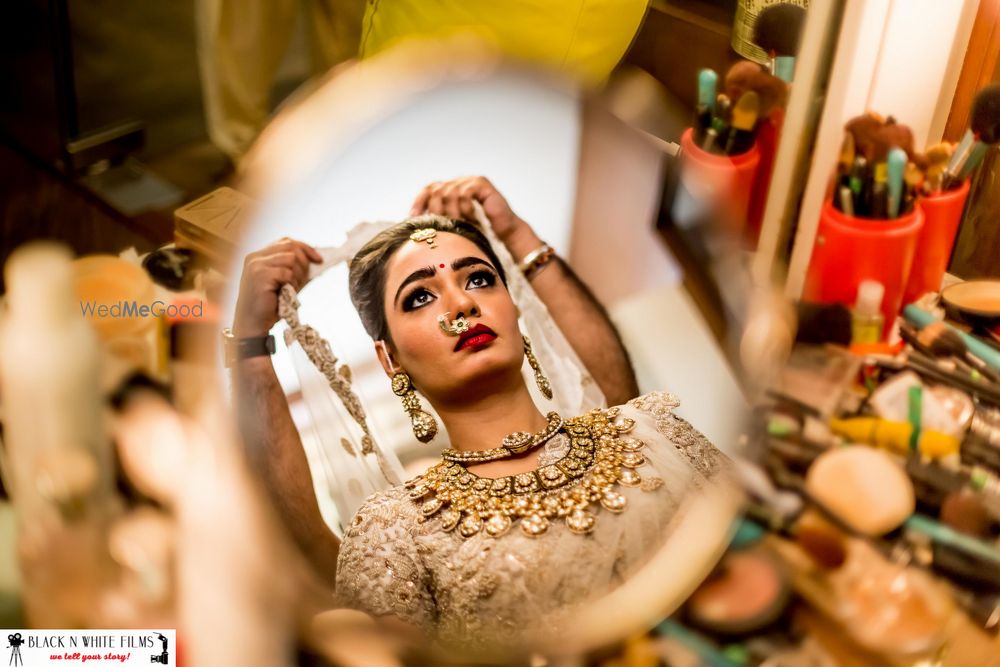 Photo of Bride Looking through the Mirror Shot