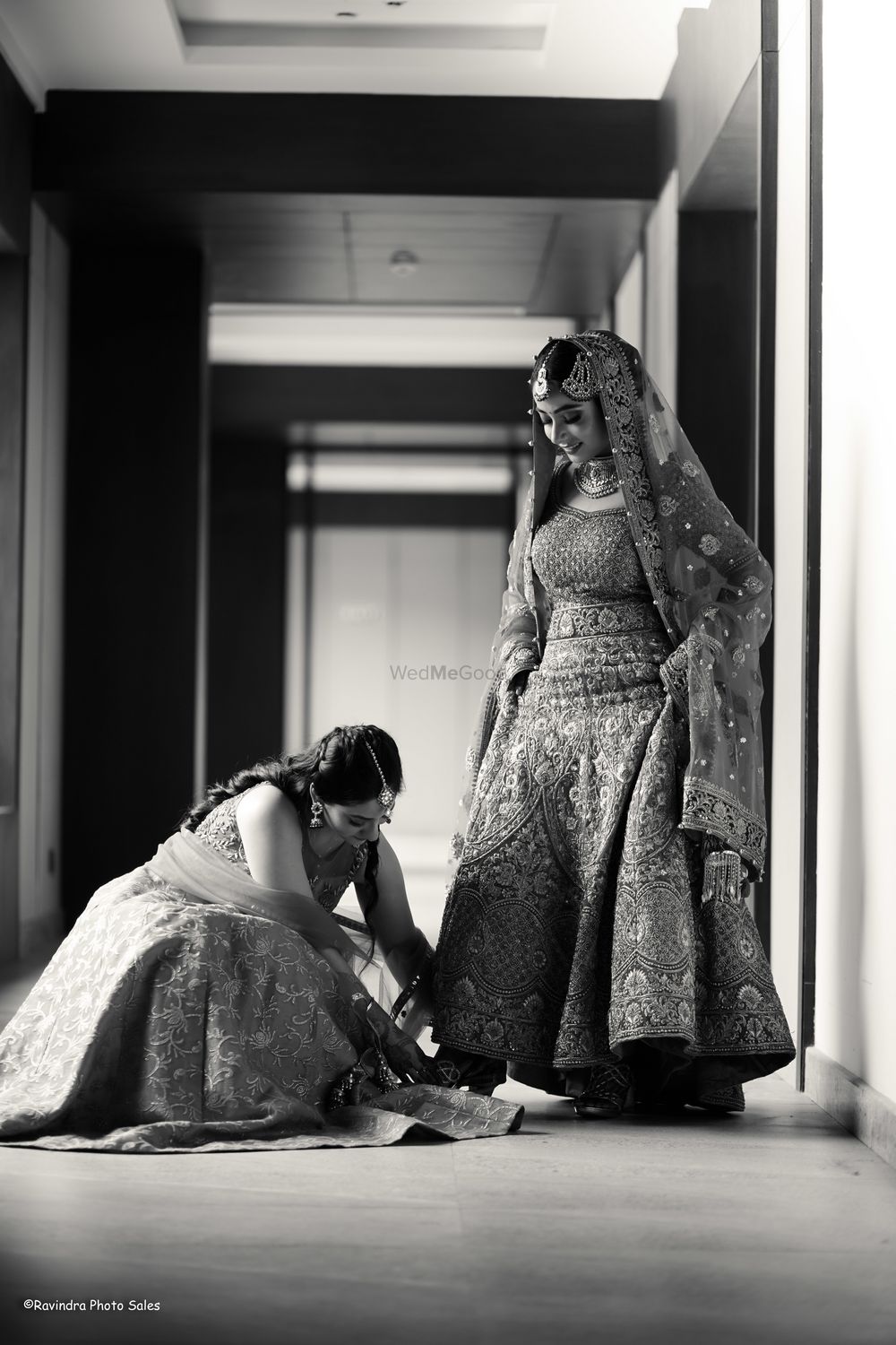 Photo of Bride getting help from her sister on her wedding day.
