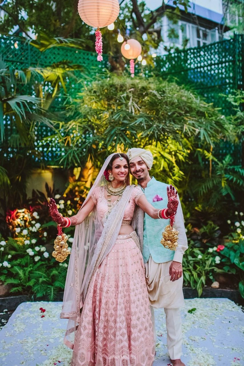 Photo of Bride and groom in contrasting pink and blue outfits