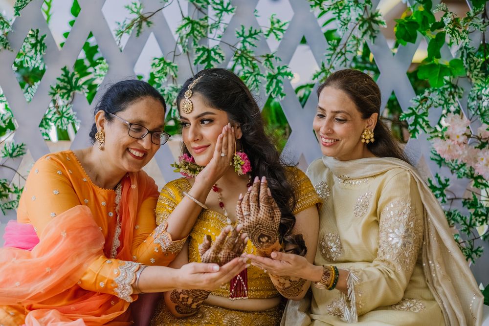 Photo of Bridal portrait with her mom and sister on mehendi