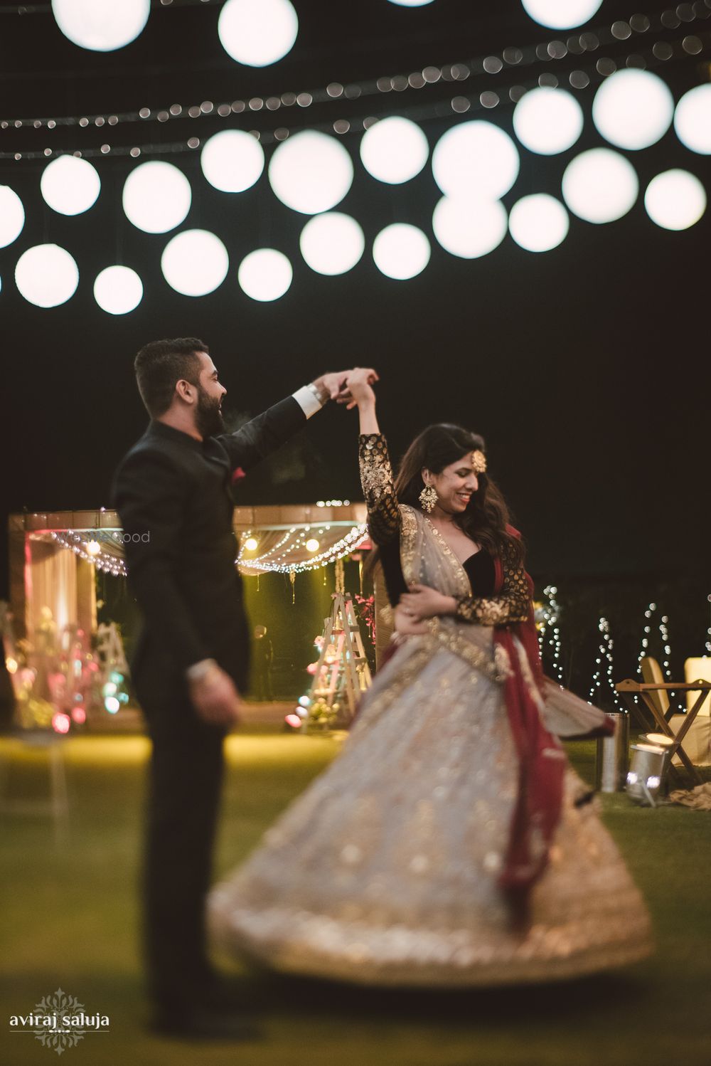 Photo of Bride and groom under lanterns