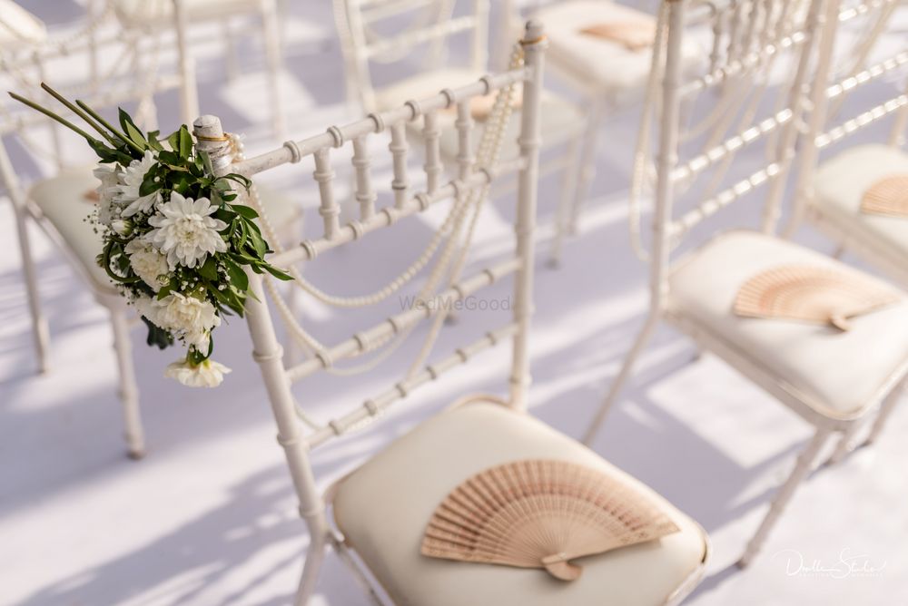 Photo of Summer wedding favour idea for guests with fans on chairs