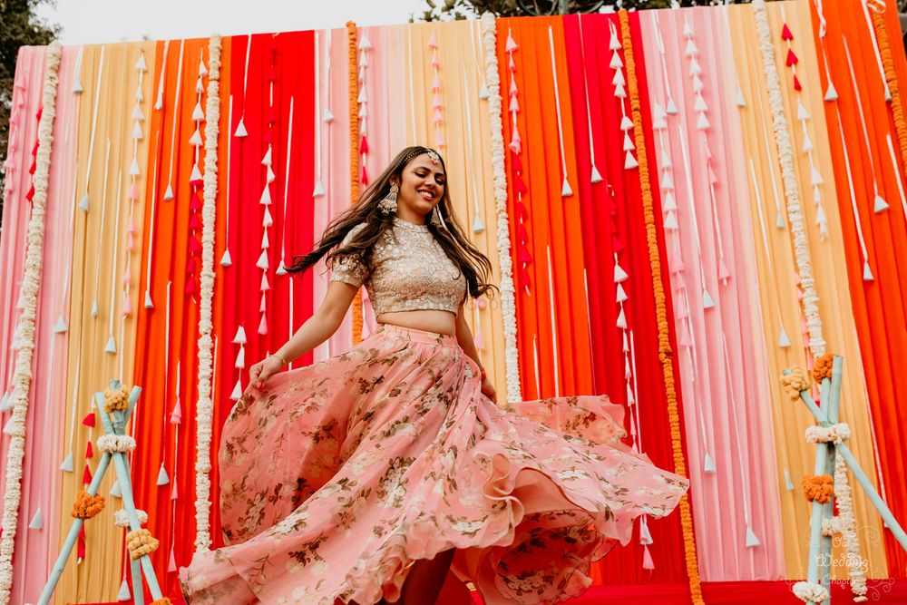Photo of Floral print lehenga for dancing bride on mehendi