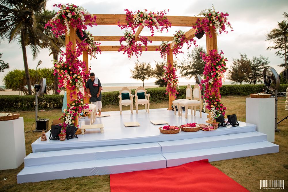 Photo of An open minimal mandap with pink flowers