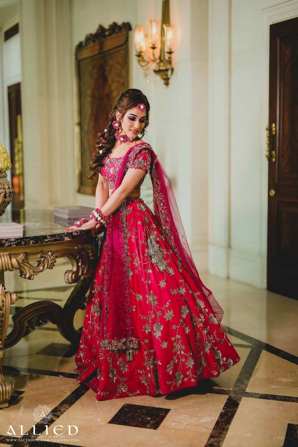 Photo of Red and pink mehendi lehenga with floral jewellery
