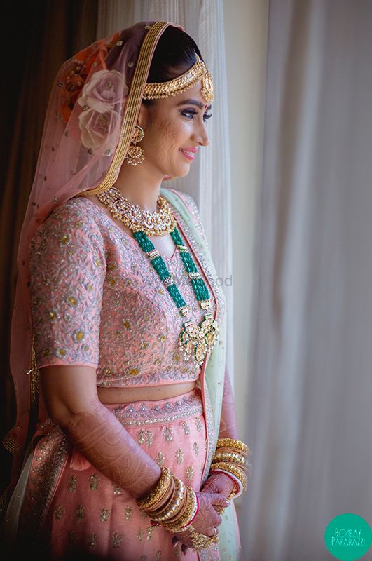 Photo of A bride in pink lehenga with contrasting jewellery