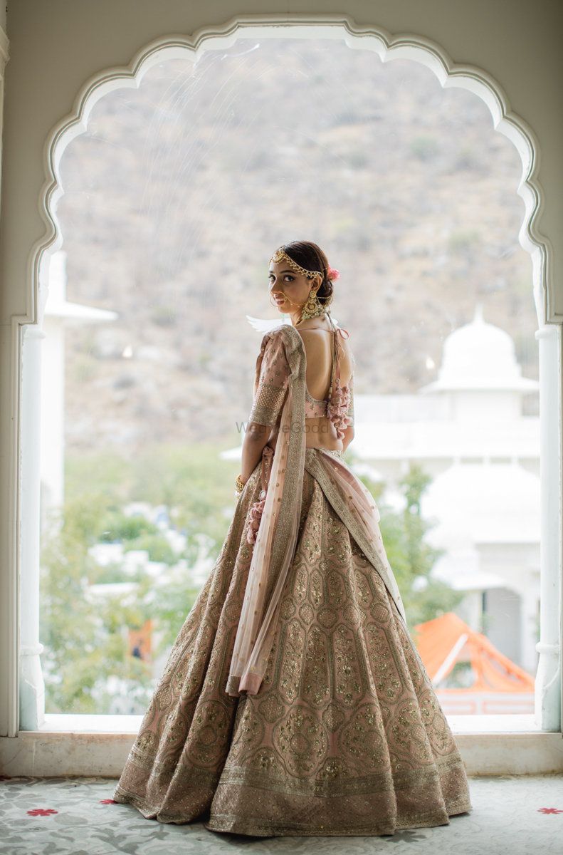 Photo of A bride in a light pink lehenga on her wedding day