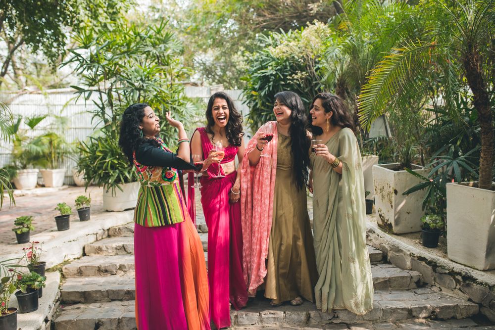 Photo of A bride chills with her bridesmaids at the sangeet ceremony