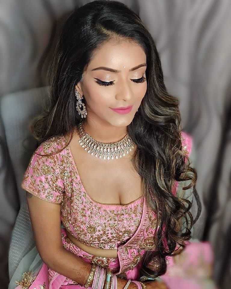 Photo of A to-be-bride in a pink outfit and dewy makeup for her engagement