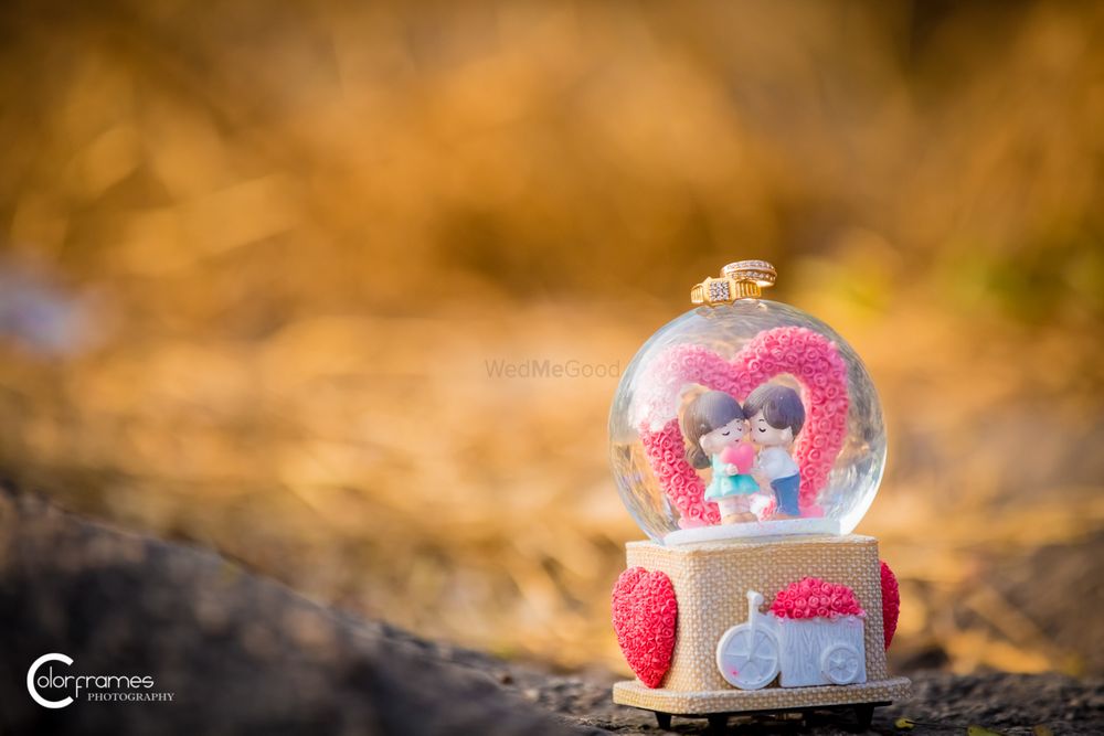 Photo of Engagement Rings on Top of a Cute Snow Globe