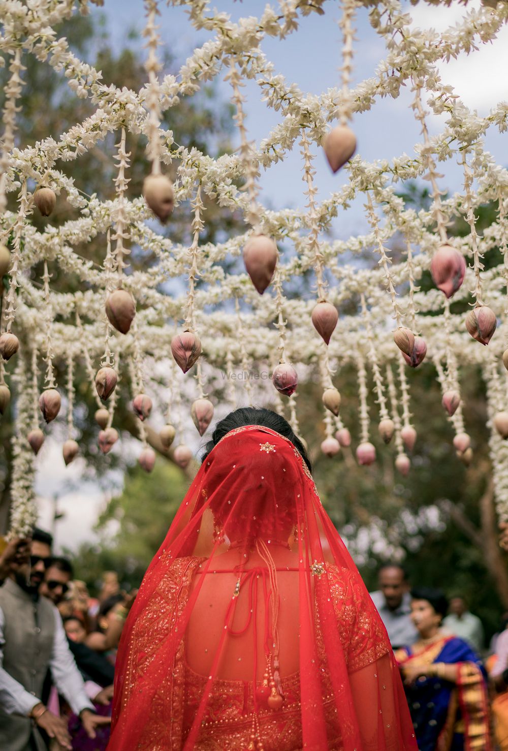 Photo of Bride under lotus phoolon ki chadar