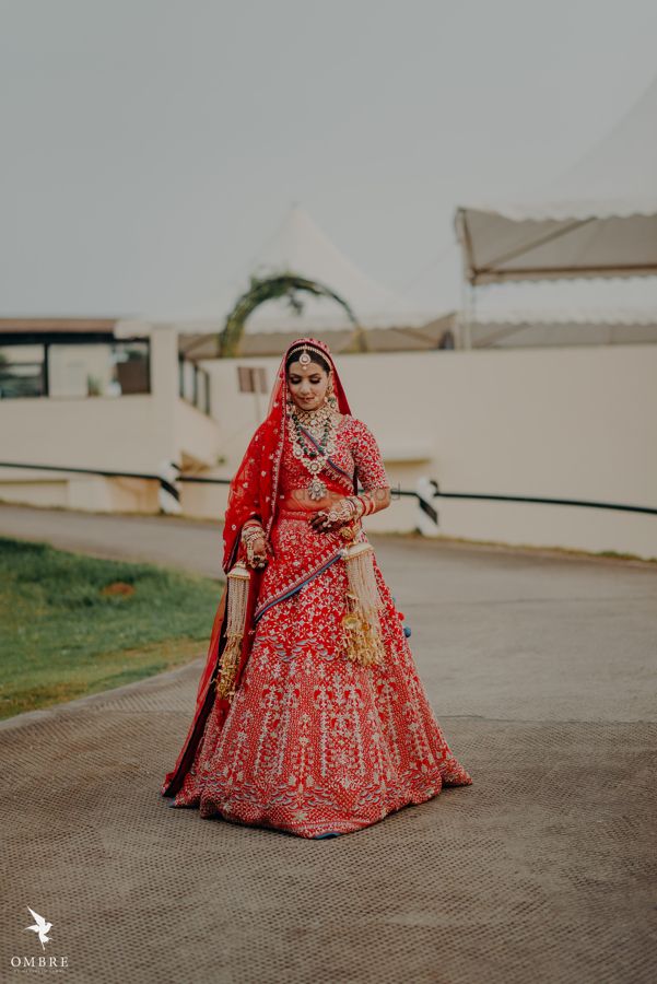Photo of gold and red embroidered bridal lehenga with kaleere